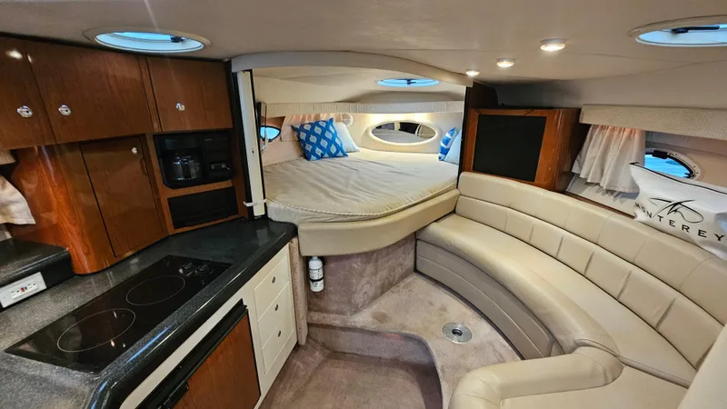 Slide: The Image of Luxurious interior of a 2003 Monterey 322 Cruiser with kitchen and cozy seating area. - 14