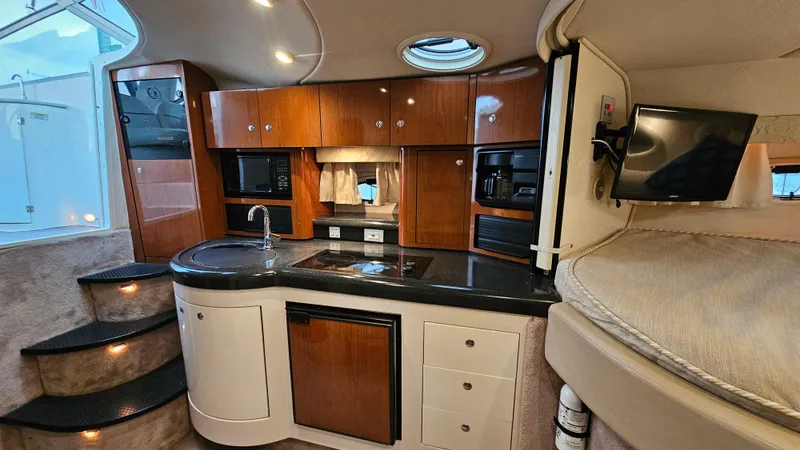 Slide: The Image of Luxurious interior of a 2003 Monterey 322 Cruiser with modern kitchen amenities. - 17