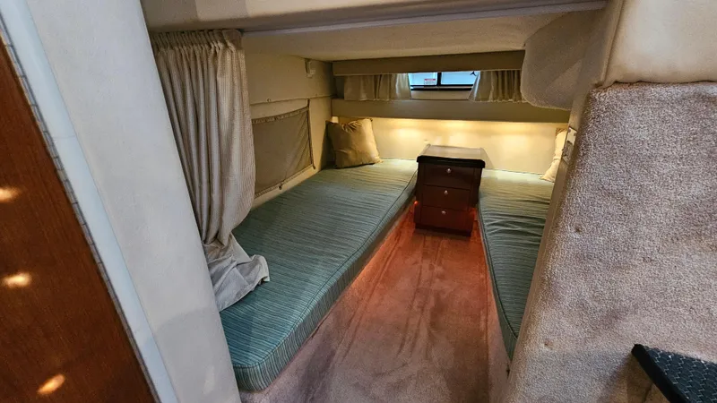 Slide: The Image of 2003 Monterey 322 Cruiser cabin interior with twin beds and a small window. - 19