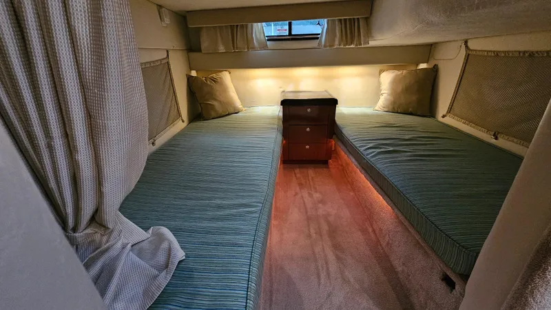 Slide: The Image of 2003 Monterey 322 Cruiser cabin with twin beds and ambient lighting. - 20