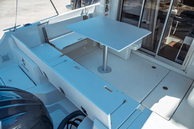 Slide: The Image of 2023 Jeanneau NC Weekender 795 Series 2 boat deck with table and seating area. - 23