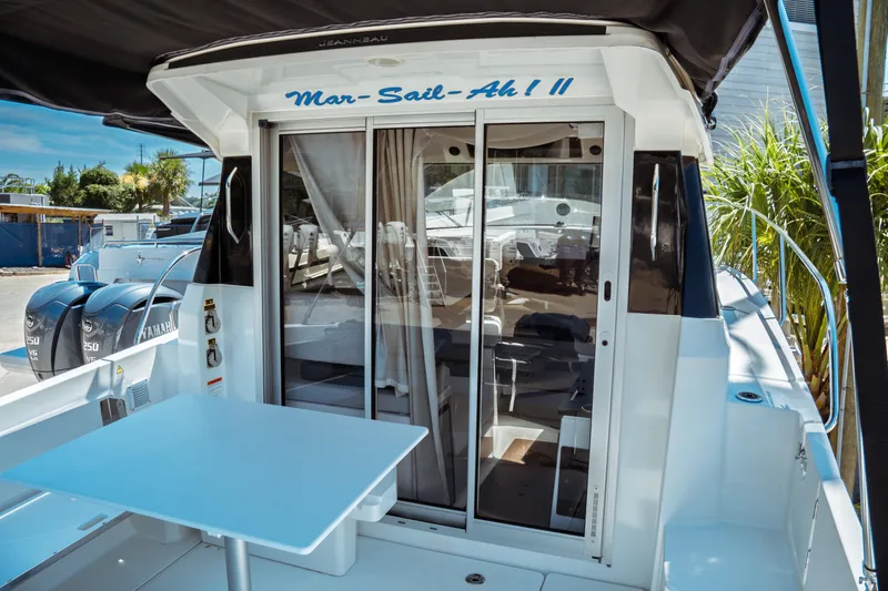 Slide: The Image of 2023 Jeanneau NC Weekender 795 Series 2 boat with sliding glass doors and outdoor seating. - 24