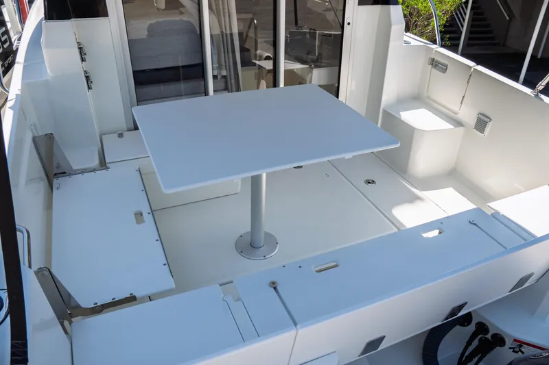 Slide: The Image of 2023 Jeanneau NC Weekender 795 Series 2 boat interior with table and seating area. - 26