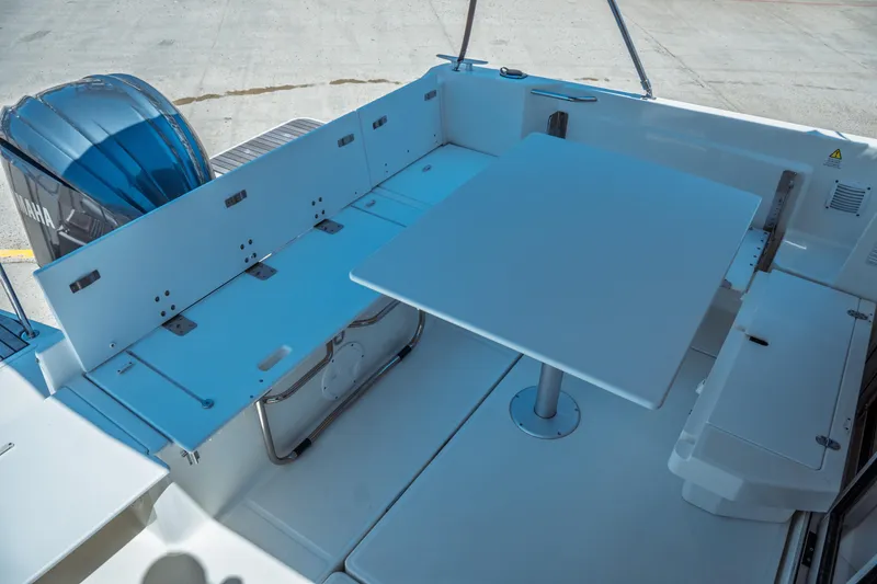 Slide: The Image of 2023 Jeanneau NC Weekender 795 Series 2 boat interior with table and seating area. - 27