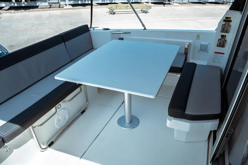 Slide: The Image of 2023 Jeanneau NC Weekender 795 Series 2 interior with seating and table. - 30