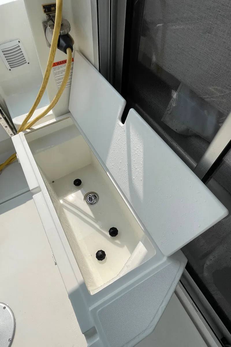 Slide: The Image of 2023 Jeanneau NC Weekender 795 Series 2 boat storage compartment open. - 33