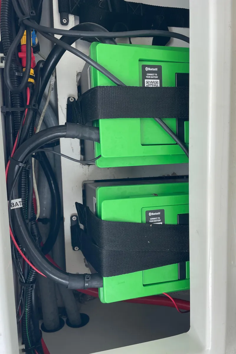 Slide: The Image of 2023 Jeanneau NC Weekender 795 Series 2 battery compartment with green batteries and wiring. - 36