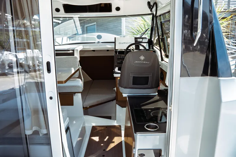 Slide: The Image of Interior view of 2023 Jeanneau NC Weekender 795 Series 2 boat, featuring helm and seating area. - 37