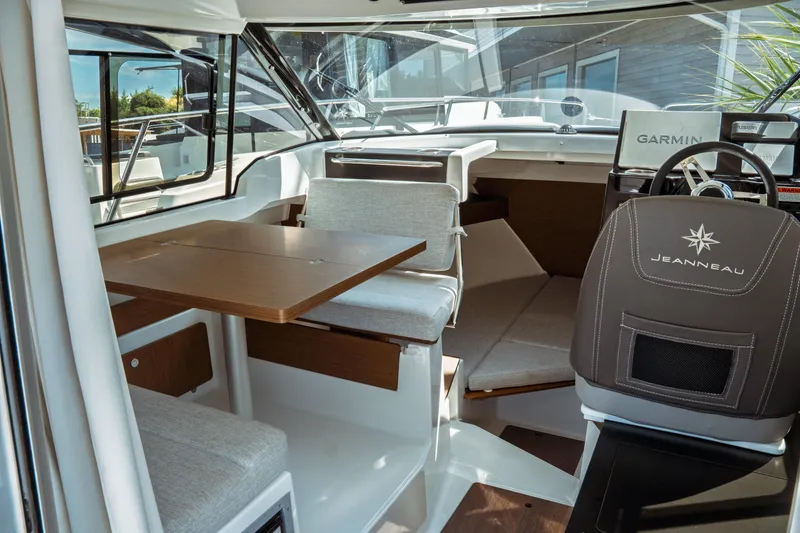 Slide: The Image of Interior of 2023 Jeanneau NC Weekender 795 Series 2, featuring seating and navigation area. - 38