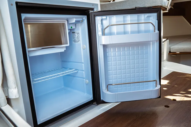 Slide: The Image of Compact refrigerator inside 2023 Jeanneau NC Weekender 795 Series 2 boat. - 42