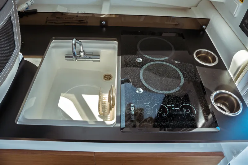 Slide: The Image of 2023 Jeanneau NC Weekender 795 Series 2 kitchen with sink and Kenyon cooktop. - 45
