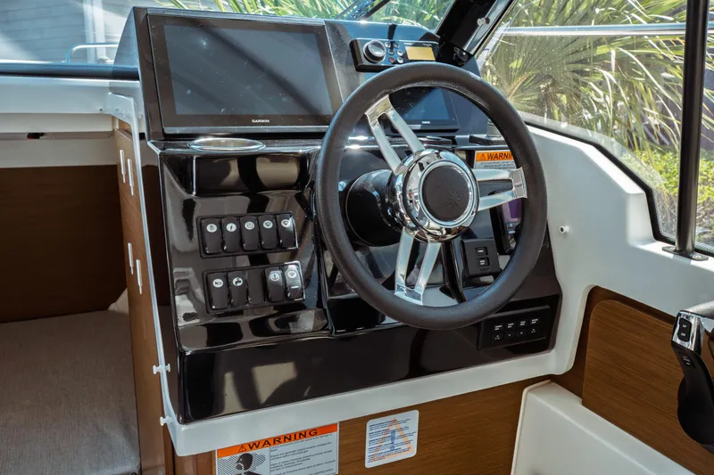 Slide: The Image of 2023 Jeanneau NC Weekender 795 Series 2 helm with modern controls and steering wheel. - 50