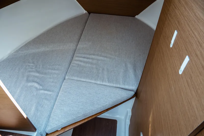 Slide: The Image of 2023 Jeanneau NC Weekender 795 Series 2 cabin interior with cushioned bed. - 59