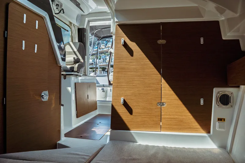 Slide: The Image of Interior of 2023 Jeanneau NC Weekender 795 Series 2, featuring wood paneling and seating. - 61