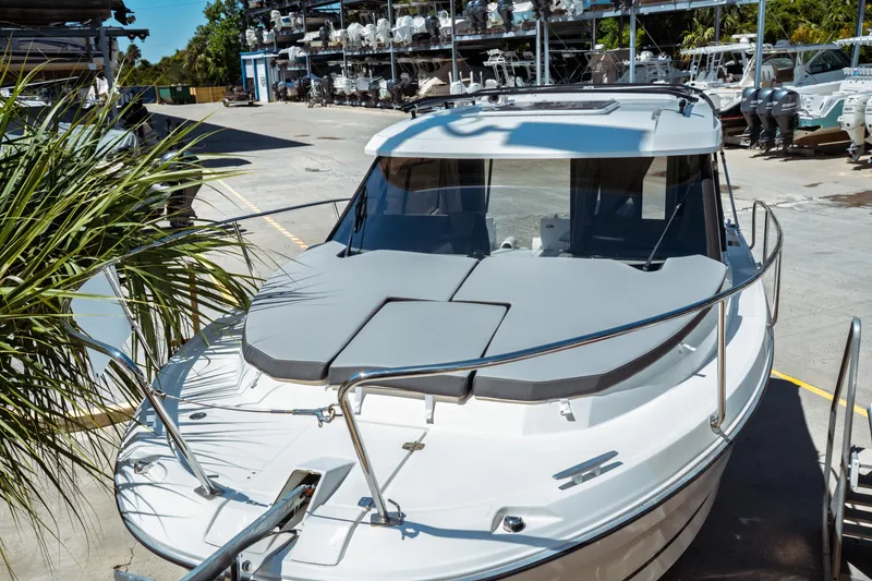 Slide: The Image of 2023 Jeanneau NC Weekender 795 Series 2 boat docked in a marina setting. - 8