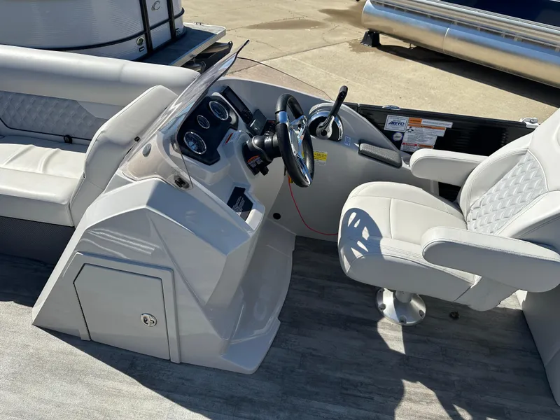 Slide: The Image of 2022 Crest Classic DLX SLRC 220 boat interior with steering console and seating. - 10