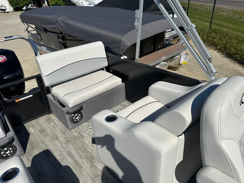 Slide: The Image of 2022 Crest Classic DLX SLRC 220 pontoon boat interior with gray seating and cup holders. - 12