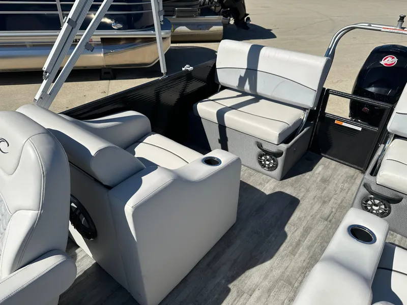 Slide: The Image of 2022 Crest Classic DLX SLRC 220 pontoon boat interior with gray seating and cup holders. - 13