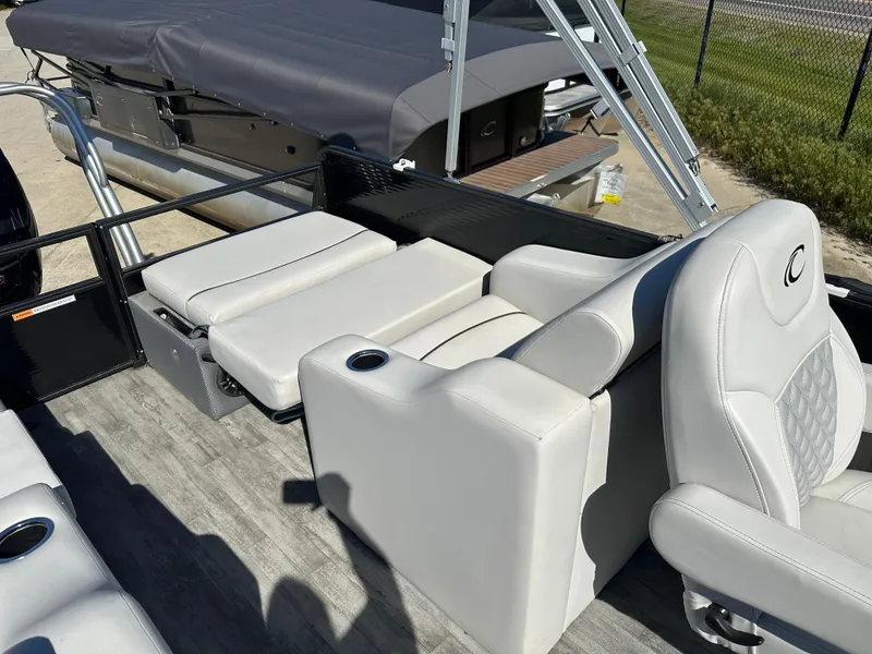 Slide: The Image of 2022 Crest Classic DLX SLRC 220 boat interior with gray seating and cup holders. - 15