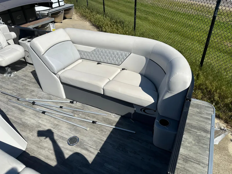 Slide: The Image of 2022 Crest Classic DLX SLRC 220 pontoon boat with gray seating and deck. - 4