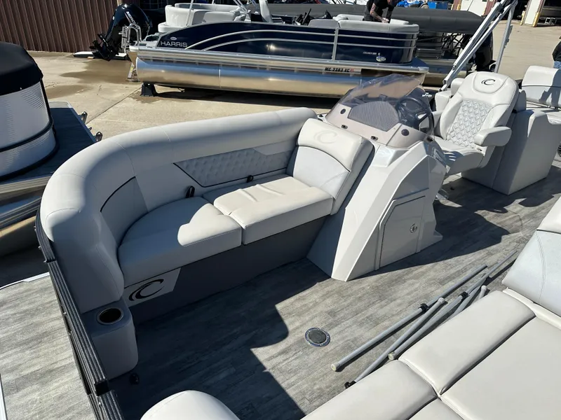 Slide: The Image of 2022 Crest Classic DLX SLRC 220 pontoon boat with spacious seating and modern design. - 5