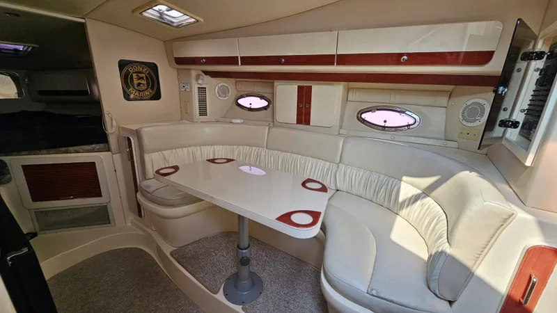 Slide: The Image of 1997 Donzi 3250 LXC cabin interior with white seating and oval windows. - 16