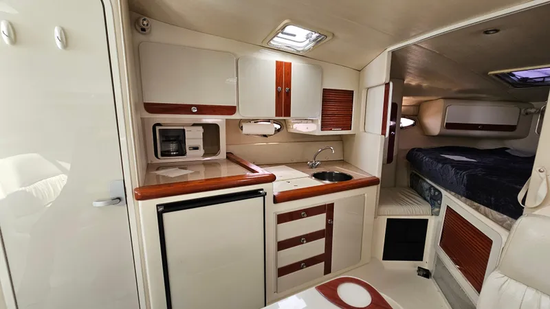 Slide: The Image of 1997 Donzi 3250 LXC cabin interior with kitchenette and sleeping area. - 17
