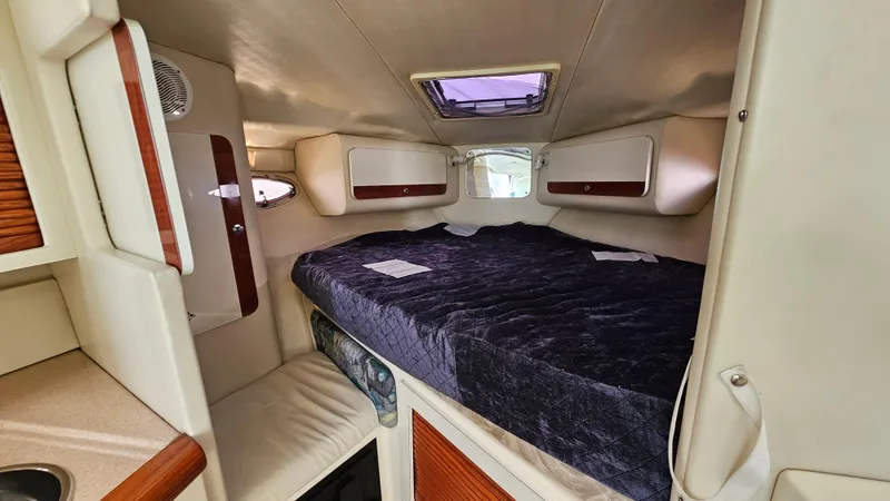 Slide: The Image of 1997 Donzi 3250 LXC cabin interior with cozy bed and storage compartments. - 19