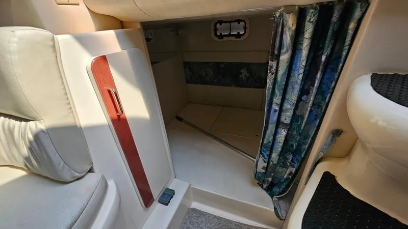 Slide: The Image of 1997 Donzi 3250 LXC cabin interior with seating and curtain. - 21