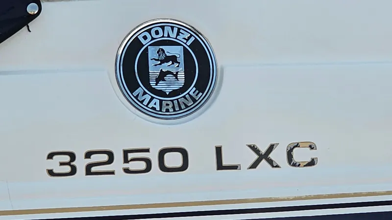 Slide: The Image of 1997 Donzi 3250 LXC boat emblem and model name on hull. - 23