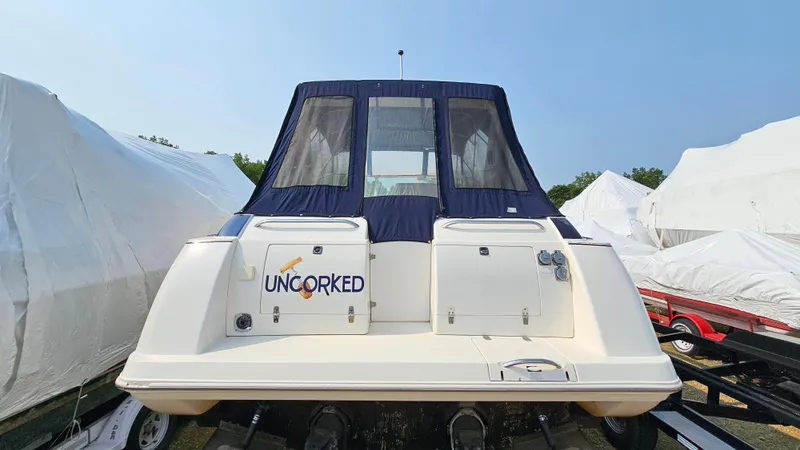 Slide: The Image of 1997 Donzi 3250 LXC boat with "Uncorked" name, docked and covered. - 5