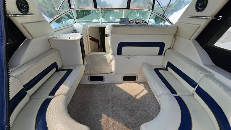 Slide: The Image of Interior of a 1997 Donzi 3250 LXC boat with white and blue seating. - 6