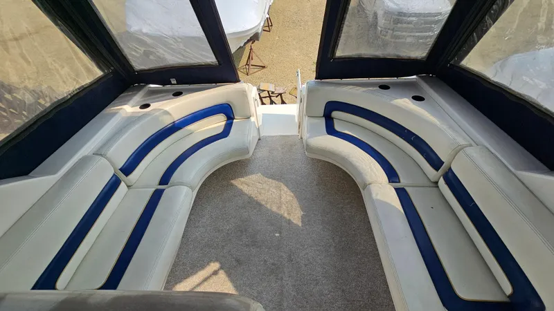 Slide: The Image of 1997 Donzi 3250 LXC boat interior with curved seating and blue accents. - 7