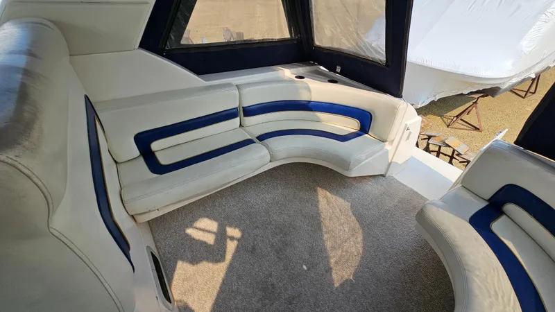 Slide: The Image of Interior seating of a 1997 Donzi 3250 LXC boat with white and blue upholstery. - 8