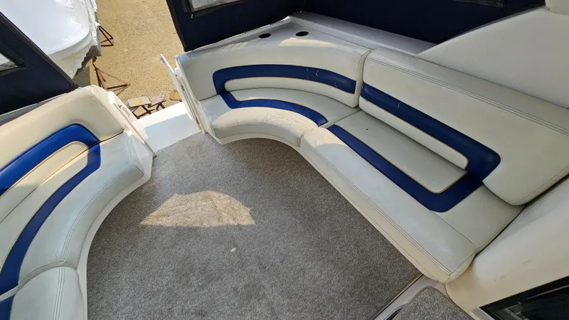 Slide: The Image of 1997 Donzi 3250 LXC boat interior with curved seating and blue accents. - 9