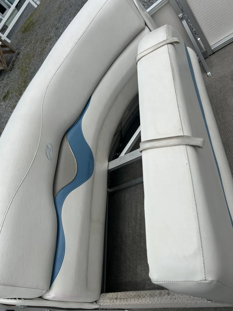Slide: The Image of 2007 Avalon Windjammer boat seating with white and blue upholstery. - 19