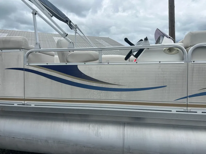 Slide: The Image of 2007 Avalon Windjammer 18' pontoon boat with blue and beige wave design. - 2