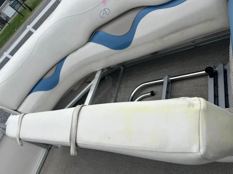 Slide: The Image of 2007 Avalon Windjammer 18' boat interior with white and blue seating. - 21