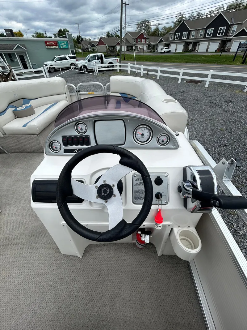 Slide: The Image of 2007 Avalon Windjammer 18' boat dashboard with steering wheel and controls. - 27