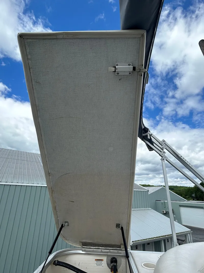Slide: The Image of 2007 Avalon Windjammer boat hatch open under a partly cloudy sky. - 30