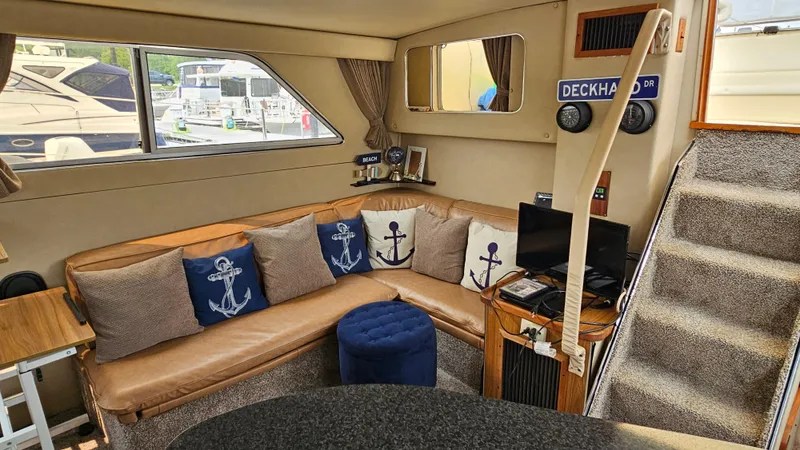 Slide: The Image of Interior of 1986 Chris-Craft 381 Catalina with nautical-themed decor and cozy seating area. - 12