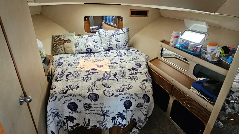 Slide: The Image of 1986 Chris-Craft 381 Catalina cabin interior with nautical-themed bedding and cozy decor. - 15
