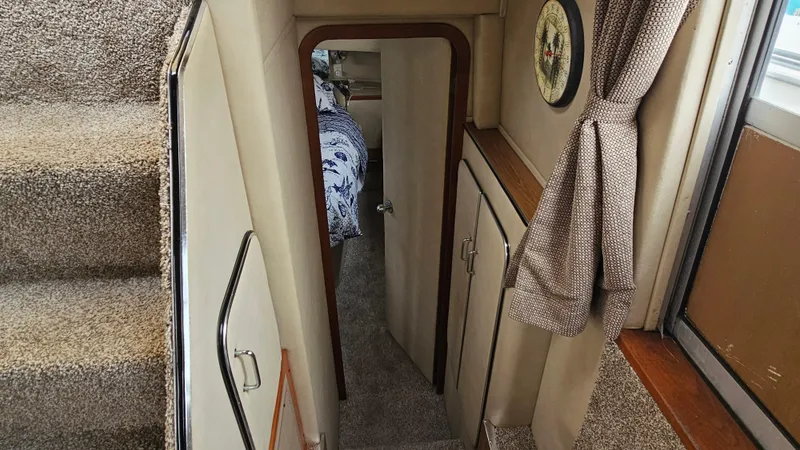 Slide: The Image of Interior view of 1986 Chris-Craft 381 Catalina, featuring stairs and cozy cabin entrance. - 18