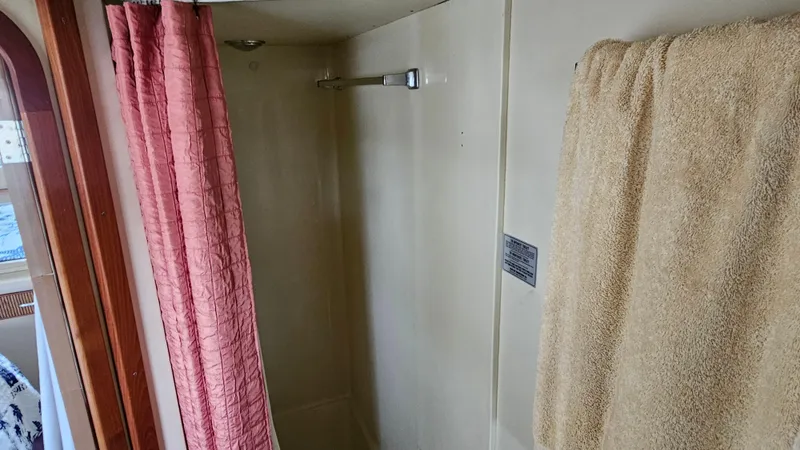 Slide: The Image of Shower area in 1986 Chris-Craft 381 Catalina yacht with pink curtain and beige towel. - 24