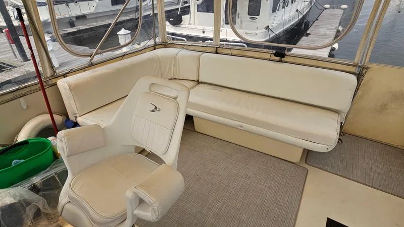 Slide: The Image of 1986 Chris-Craft 381 Catalina interior with white seating and helm chair. - 4