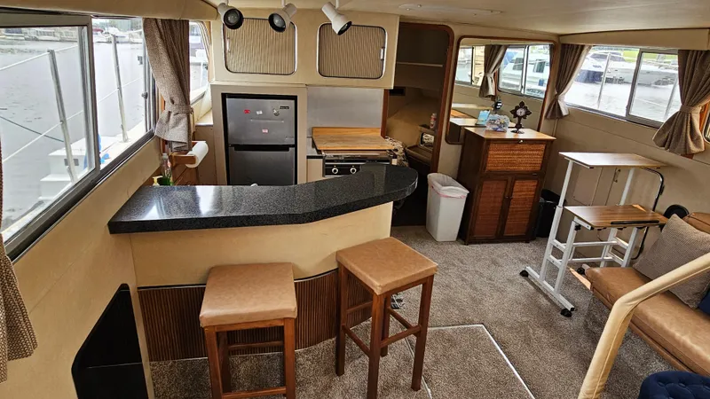 Slide: The Image of Interior of 1986 Chris-Craft 381 Catalina yacht with modern kitchen and seating area. - 9