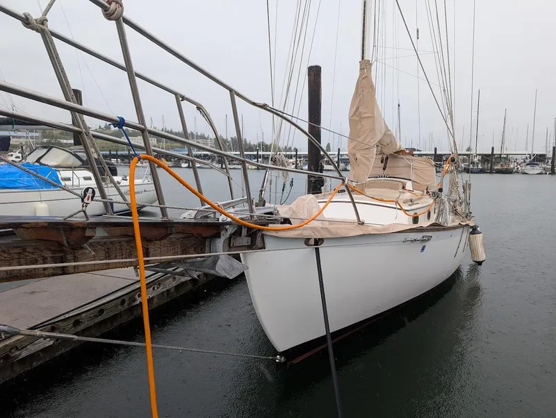 Slide: The Image of 1977 Alajuela 38 Mk1 sailboat docked at a marina on a cloudy day. - 15