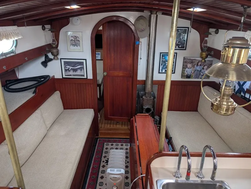 Slide: The Image of Interior of a 1977 Alajuela 38 Mk1 sailboat with cozy seating and nautical decor. - 22