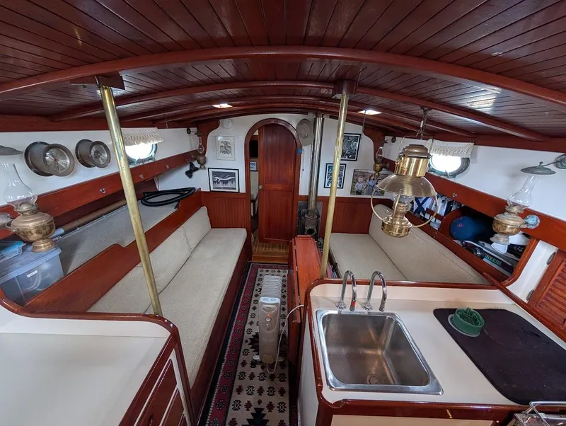 Slide: The Image of Interior of a 1977 Alajuela 38 Mk1 sailboat with wooden finishes and cozy seating. - 23
