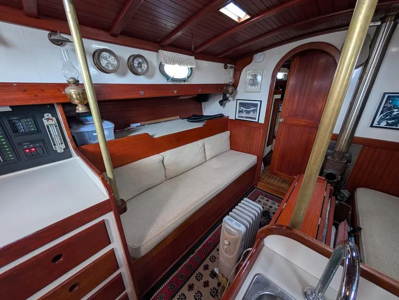 Slide: The Image of Interior of a 1977 Alajuela 38 Mk1 sailboat with cozy seating and nautical decor. - 24